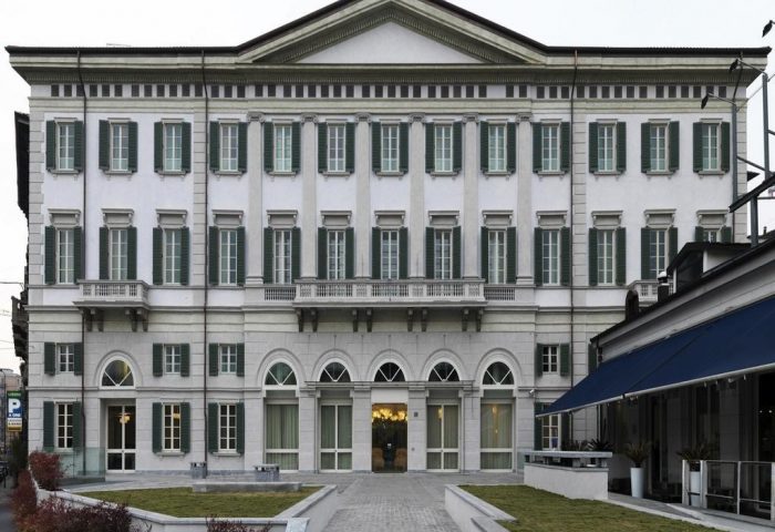 NH Milano Palazzo Moscova facade. Gay-friendly hotel in Milan, Italy. Elegant architecture with green shutters. A top choice for gay travelers.