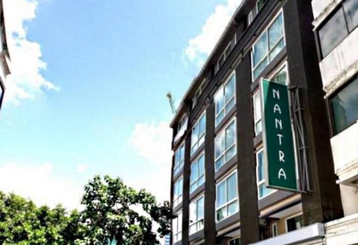 Nantra Silom Hotel exterior. Gay-friendly hotel in Bangkok's Silom district. Modern building with a green sign. Great choice for gay travelers.