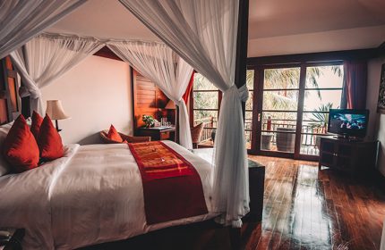 Napasai, A Belmond Hotel, Koh Samui: Gay-friendly hotel room with four-poster bed, balcony, and tropical view. Luxury travel for gay men.