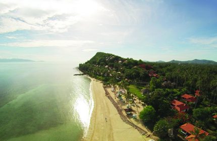Napasai, A Belmond Hotel, Koh Samui aerial view. Gay-friendly hotel with beach, trees, and villas. Tropical paradise for gay men travel.