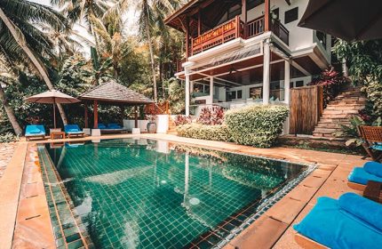Napasai, A Belmond Hotel, Koh Samui pool view. Gay-friendly hotel with lush greenery, pool, and cabana. Tropical getaway for gay men's travel.