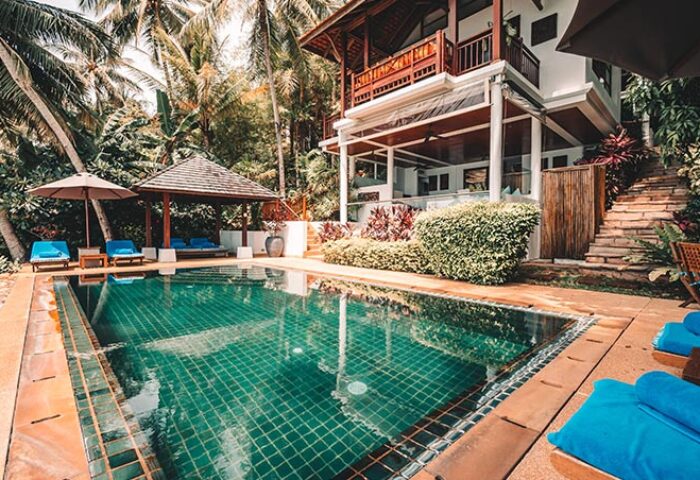 Napasai, A Belmond Hotel, Koh Samui pool view. Gay-friendly hotel with lush greenery, pool, and cabana. Tropical getaway for gay men's travel.