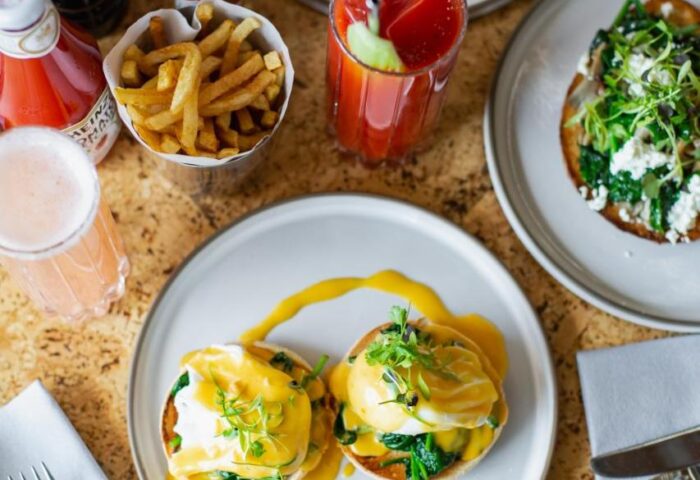Brunch at Native Manchester, a gay-friendly hotel. Eggs Benedict, salmon, toast, fries, and Bloody Marys. Delicious food for gay travelers.