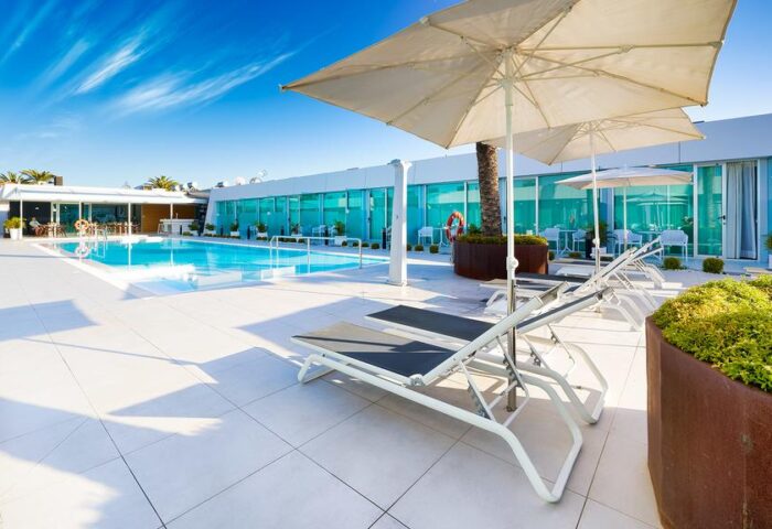 Hotel Nayra Adults Only pool area. Gay-friendly hotel with sun loungers and parasols. Modern design. Ideal for gay men travel.