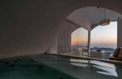 Nefeles Luxury Suites gay-friendly hotel view. Jacuzzi and sunset view from a suite's balcony. Romantic Santorini experience for gay men.