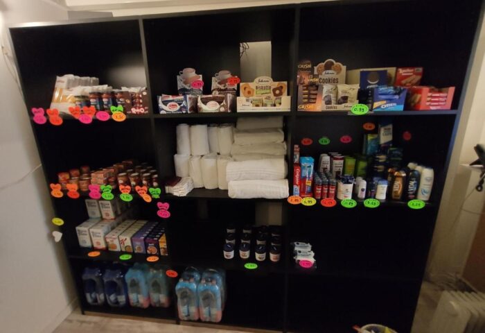 Gay-Friendly New Generation Hostel Milan Center's shop. Shelves stocked with snacks, toiletries, and essentials for a comfortable stay.