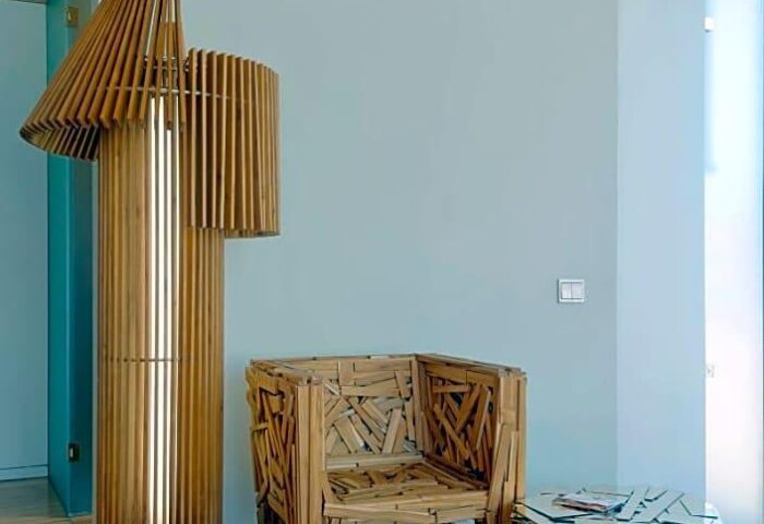 New Hotel room decor: Wooden chair and lamp. Gay-friendly hotel design with unique furniture. Modern interior at this new hotel.