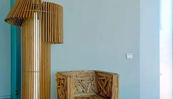 New Hotel room decor: Wooden chair and lamp. Gay-friendly hotel design with unique furniture. Modern interior at this new hotel.