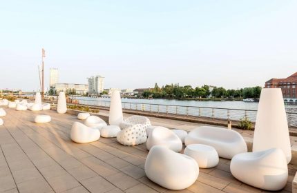 Nhow Berlin Hotel's outdoor lounge area by the river. Modern white furniture for gay travelers. Gay-Friendly Hotel Nhow Berlin Hotel.