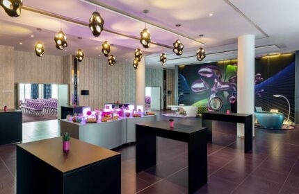 Nhow Berlin Hotel's lobby. Gay-friendly hotel with unique design, modern furniture, and stylish lighting. Buffet with snacks. Perfect for gay travel.