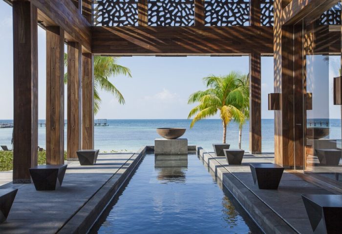 Nizuc Resort and Spa view. Water feature, palm trees, and ocean view. Gay-friendly hotel for gay men travel in Cancun, Mexico.