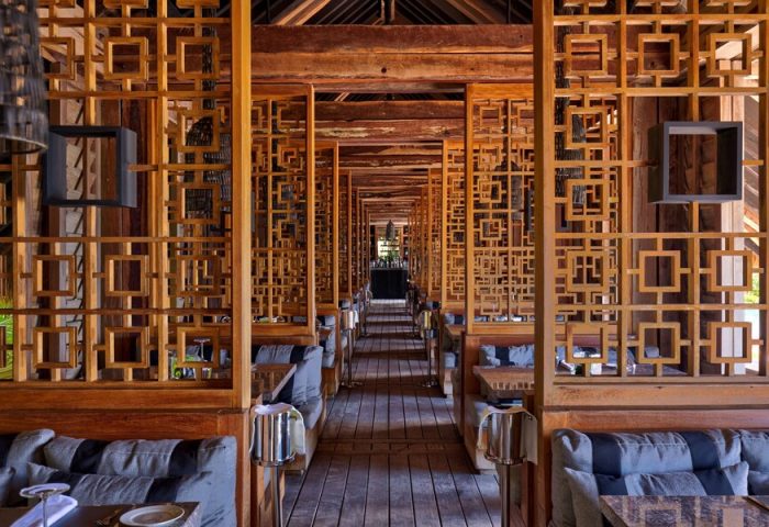 Nizuc Resort and Spa gay-friendly hotel restaurant. Wooden design with tables and sofas. A great place for gay men to relax and enjoy.