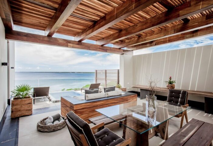 Nizuc Resort and Spa's gay-friendly hotel patio. Outdoor seating area with ocean view. Luxury travel for gay men at Nizuc Resort.