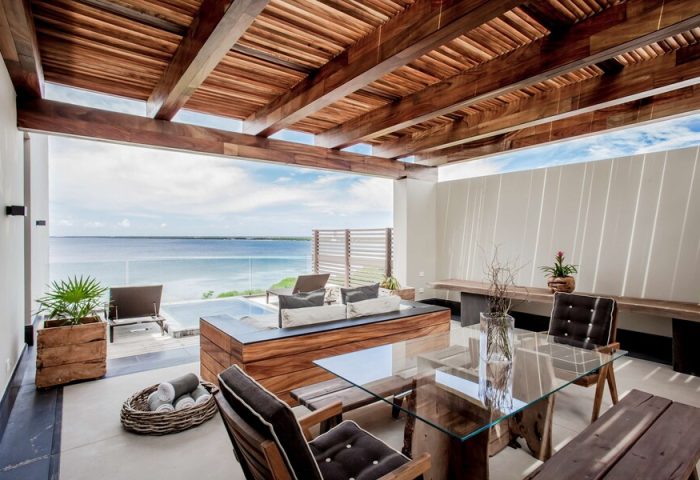 Nizuc Resort and Spa's gay-friendly hotel patio. Outdoor seating area with ocean view. Luxury travel for gay men at Nizuc Resort.