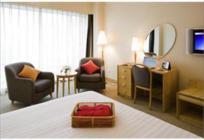 Novotel Beijing Xinqiao hotel room. Gay-friendly hotel with bed, desk, chairs, and window. Comfortable accommodations for gay travelers in Beijing.