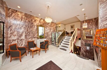 Novum Hotel Leonet Köln Altstadt lobby. Gay-friendly hotel interior with seating, stairs, & marble walls in Cologne. Gay travel advice.