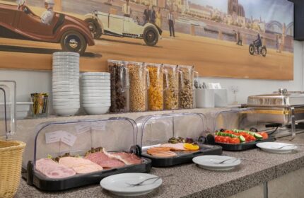 Breakfast buffet at Novum Hotel Leonet Köln Altstadt, a gay-friendly hotel. Cold cuts, cereals, and warm dishes are available for guests.