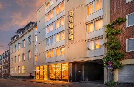 Novum Hotel Leonet Köln Altstadt exterior. Gay-friendly hotel in Cologne's old town. Facade view with HOTEL sign. Travel destination.