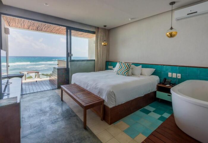 O' Tulum Boutique Hotel Adults Only room. Gay-friendly hotel with ocean view, bed, and tub. Perfect for gay travel in Tulum.