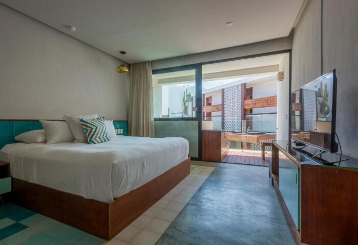 O' Tulum Boutique Hotel adults-only room. Gay-friendly hotel with a king bed, balcony, and modern decor. Perfect for gay travel in Tulum.