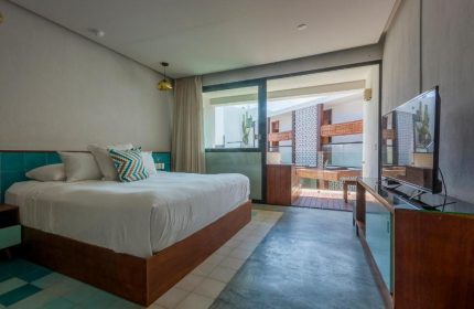 O' Tulum Boutique Hotel adults-only room. Gay-friendly hotel with a king bed, balcony, and modern decor. Perfect for gay travel in Tulum.