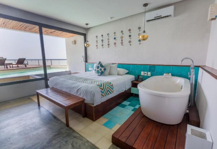 O' Tulum Boutique Hotel Adults Only room. King bed, bathtub, and pool view. Gay-friendly hotel in Tulum, Mexico for gay men's travel.
