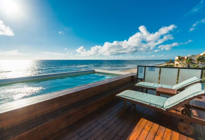 O' Tulum Boutique Hotel adults-only rooftop pool and sunbeds overlooking the beach. Gay-friendly hotel in Tulum, Mexico for gay men travelers.