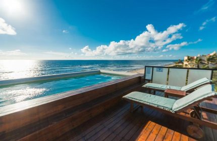 O' Tulum Boutique Hotel adults-only rooftop pool and sunbeds overlooking the beach. Gay-friendly hotel in Tulum, Mexico for gay men travelers.