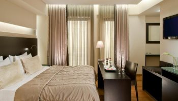 O&B Athens Boutique Hotel gay-friendly room. Modern design, double bed, desk with snacks, and TV. Ideal for gay travelers in Athens.