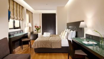O&B Athens Boutique Hotel room. Gay-friendly hotel with modern design, desk, bed, and closet. Ideal for gay travel in Athens, Greece.