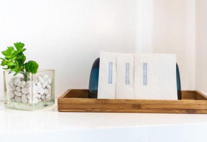 OZO Chaweng Samui detail. Plant in pebbles, wooden tray with tissues. Gay-friendly hotel ambiance, welcoming details for gay travelers.