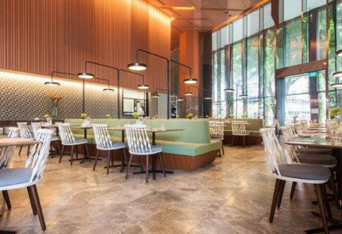 Oasia Hotel Downtown Singapore restaurant. Gay-friendly hotel dining with modern chairs, tables, and booth seating. Far East Hospitality.