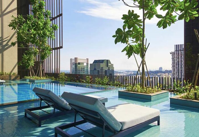Oasia Hotel Downtown Singapore pool. Gay-friendly hotel rooftop pool with lounge chairs and city view. Far East Hospitality hotel.