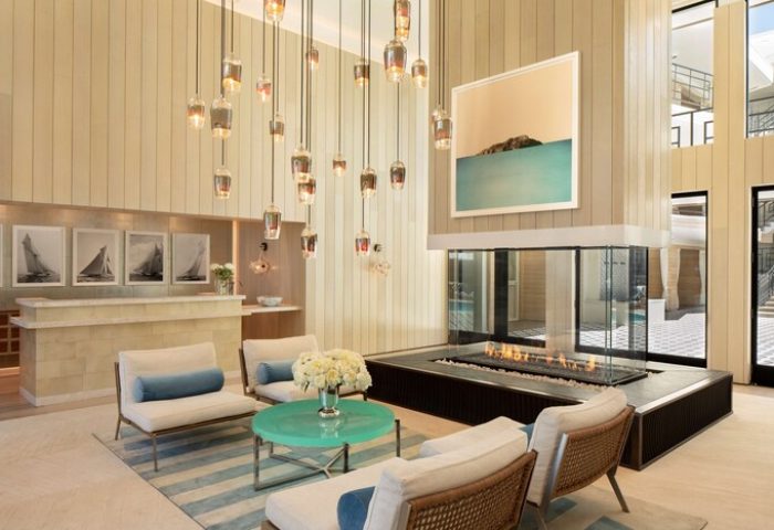 Oceana Santa Monica, LXR Hotels & Resorts lobby. Gay-friendly hotel with modern design, fireplace, seating area, and stylish lighting.
