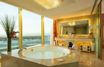 Okada Manila gay-friendly hotel bathroom. Luxurious suite with a view, bathtub, and marble finishes. Perfect for gay travel and relaxation.