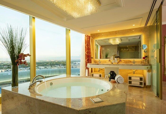 Okada Manila gay-friendly hotel bathroom. Luxurious suite with a view, bathtub, and marble finishes. Perfect for gay travel and relaxation.