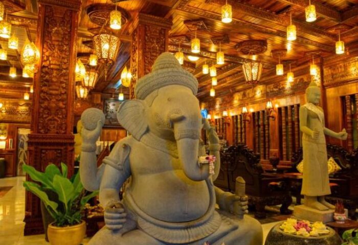 Okay Boutique Hotel interior. Gay-friendly Hotel with Ganesha statue, wooden carvings, and warm lighting. A unique stay for gay travelers.
