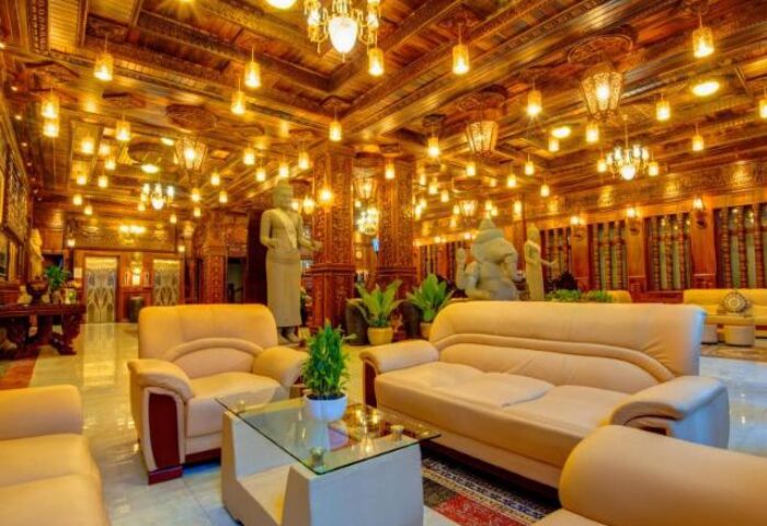 Okay Boutique Hotel's lobby. Gay-friendly hotel with ornate wood ceilings, statues, and seating. Luxury travel for gay men in a stylish hotel.