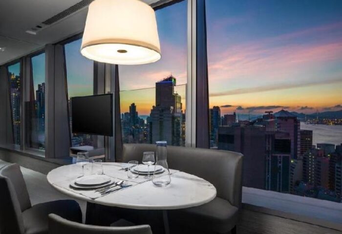 One96, a gay-friendly hotel: Dining area with city view at sunset. Modern design, perfect for LGBT travelers seeking stylish accommodations.