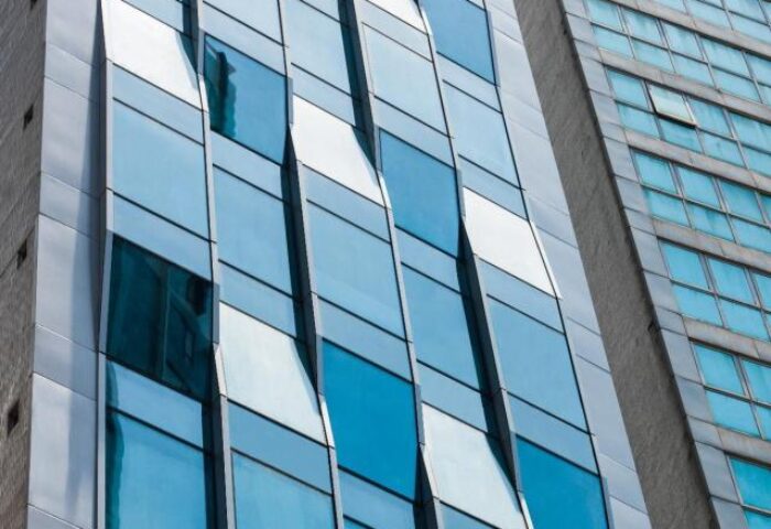 Facade of One96, a gay-friendly hotel. Modern architecture with blue glass windows. A great choice for gay travelers seeking comfort.