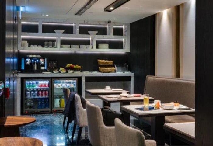 One96 Gay-Friendly Hotel: Breakfast area with tables, chairs, and a refreshment station. A great choice for gay men's travel.