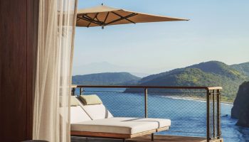 One&Only Mandarina gay-friendly hotel room view. Balcony with lounge chairs overlooks the ocean. Luxury travel for gay men.