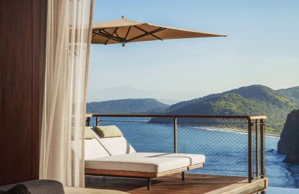 One&Only Mandarina gay-friendly hotel room view. Balcony with lounge chairs overlooks the ocean. Luxury travel for gay men.