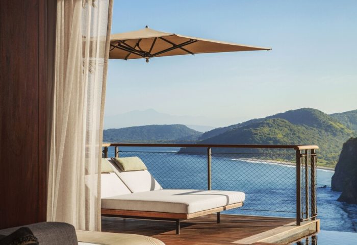 One&Only Mandarina gay-friendly hotel room view. Balcony with lounge chairs overlooks the ocean. Luxury travel for gay men.