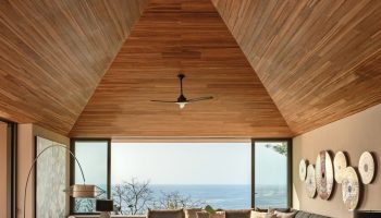 One&Only Mandarina's luxury gay-friendly hotel suite. Modern design with a high wood ceiling, ocean view, and stylish furniture.