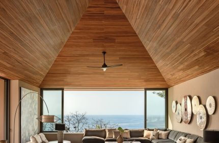 One&Only Mandarina's luxury gay-friendly hotel suite. Modern design with a high wood ceiling, ocean view, and stylish furniture.