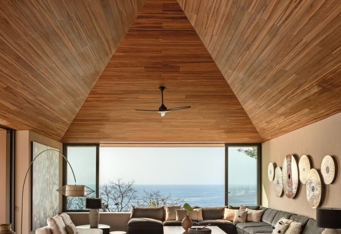 One&Only Mandarina's luxury gay-friendly hotel suite. Modern design with a high wood ceiling, ocean view, and stylish furniture.