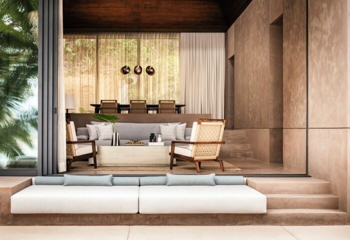 One&Only Mandarina's gay-friendly hotel suite. Modern design with a neutral color palette, plush seating, and open-air living space. Luxury travel.