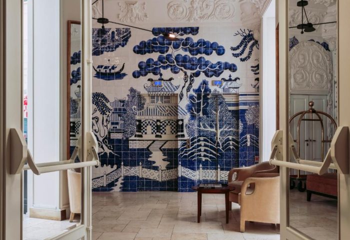 Only YOU Hotel Atocha's gay-friendly design: Blue & white tiled mural, chairs, and open doors. A stylish, welcoming space for gay travelers.