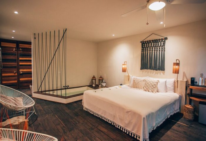 Orchid Beach House Adults Only gay-friendly hotel room. Jacuzzi tub, king bed, and modern decor. Ideal for gay travel and relaxation.